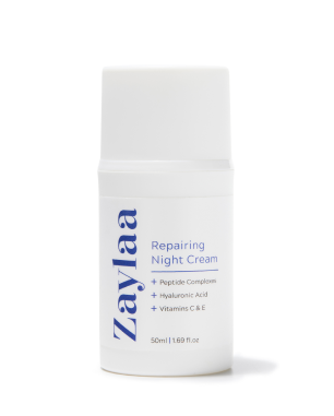 Image of a white bottle with a blue label that says 'Repairing Night Cream' by Zaylaa on a white background