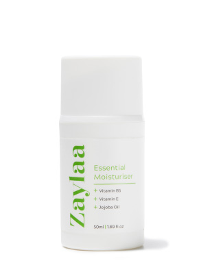 A white bottle of essential oil moisturizer from Zaylaa with black text. The text says "Essential Moisture 50."